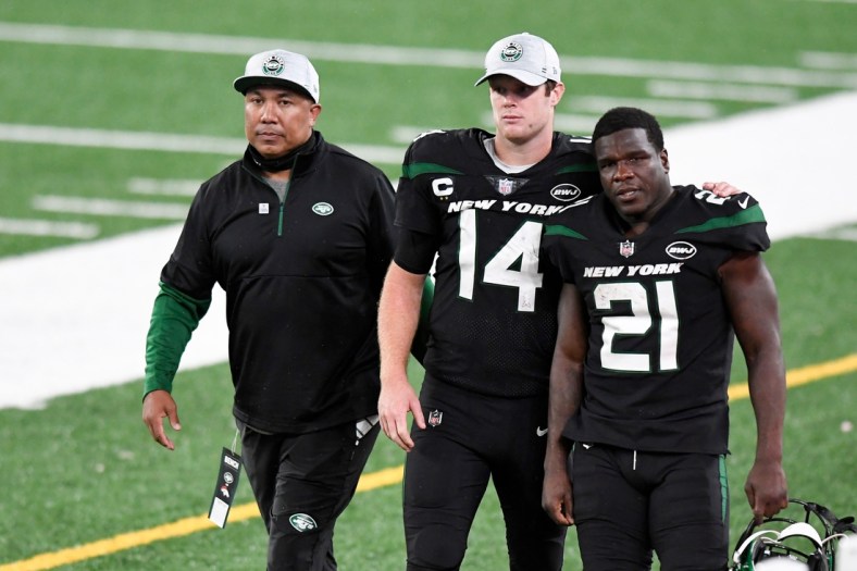 (from left) Offensive coach Hines Ward, New York Jets quarterback Sam Darnold (14), and running back Frank Gore (21) walk off the field after losing to the Denver Broncos, 37-28, at MetLife Stadium on Thursday, Oct. 1, 2020, in East Rutherford.

Nfl Jets Broncos