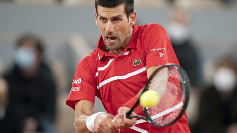 Oct 11, 2020;  Paris, France; Novak Djokovic (SRB) in action during his match against Rafael Nadal (ESP) on day 15 at Stade Roland Garros. Mandatory Credit: Susan Mullane-USA TODAY Sports