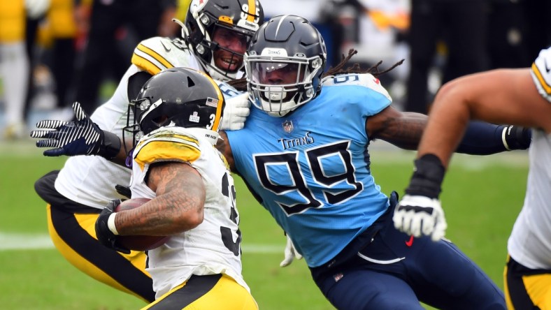 Oct 25, 2020; Nashville, Tennessee, USA; Tennessee Titans outside linebacker Jadeveon Clowney (99) tackles Pittsburgh Steelers running back James Conner (30) at Nissan Stadium. Mandatory Credit: Christopher Hanewinckel-USA TODAY Sports