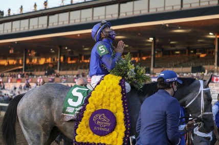 Nov 6, 2020; Lexington, KY, USA; Luis Saez aboard Essential Quality (5) reacts after winning the Breeder's Cup Juvenile race during the 37th Breeders Cup World Championship at Keeneland Race Track. Mandatory Credit: Katie Stratman-USA TODAY Sports