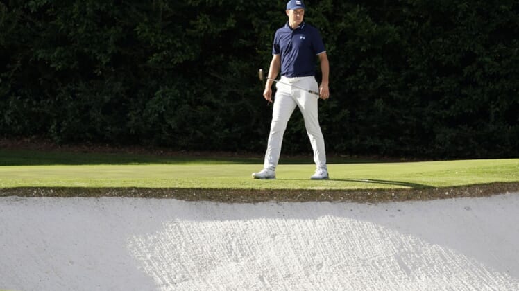 Nov 10, 2020; Augusta, Georgia, USA; Jordan Spieth surveys the bunker at the fourth green during a practice round for The Masters golf tournament at Augusta National GC. Mandatory Credit: Rob Schumacher-USA TODAY Sports