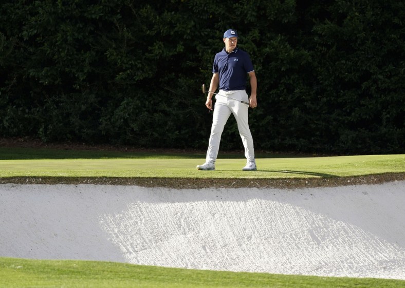 Nov 10, 2020; Augusta, Georgia, USA; Jordan Spieth surveys the bunker at the fourth green during a practice round for The Masters golf tournament at Augusta National GC. Mandatory Credit: Rob Schumacher-USA TODAY Sports