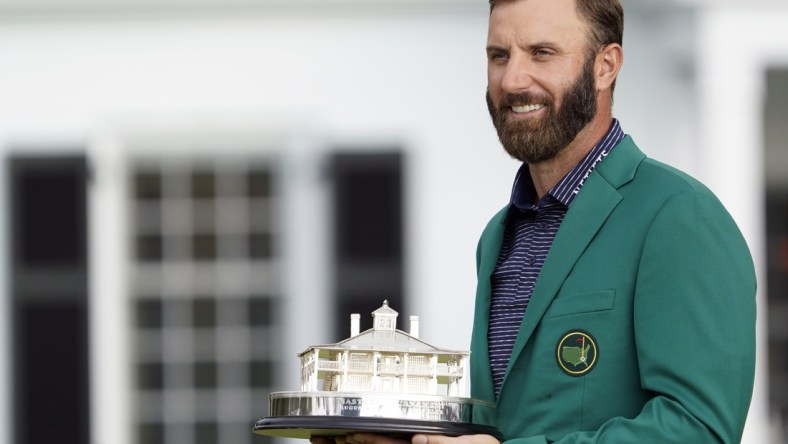 Nov 15, 2020; Augusta, Georgia, USA; Dustin Johnson celebrates with the Masters Trophy after winning The Masters golf tournament at Augusta National GC. Michael Madrid-USA TODAY Sports