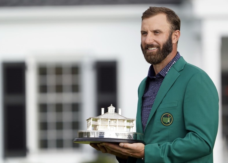 Nov 15, 2020; Augusta, Georgia, USA; Dustin Johnson celebrates with the Masters Trophy after winning The Masters golf tournament at Augusta National GC. Michael Madrid-USA TODAY Sports