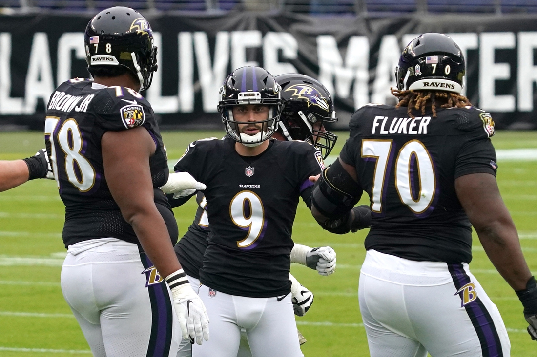 Nov 22, 2020; Baltimore, Maryland, USA; Baltimore Ravens   kicker Justin Tucker (9) celebrates a first quarter field goal against the Tennessee Titans with tackles Orlando Brown (78) and DJ Fluker (70) at M&T Bank Stadium. Mandatory Credit: Mitch Stringer-USA TODAY Sports