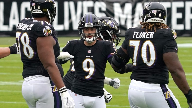 Nov 22, 2020; Baltimore, Maryland, USA; Baltimore Ravens   kicker Justin Tucker (9) celebrates a first quarter field goal against the Tennessee Titans with tackles Orlando Brown (78) and DJ Fluker (70) at M&T Bank Stadium. Mandatory Credit: Mitch Stringer-USA TODAY Sports