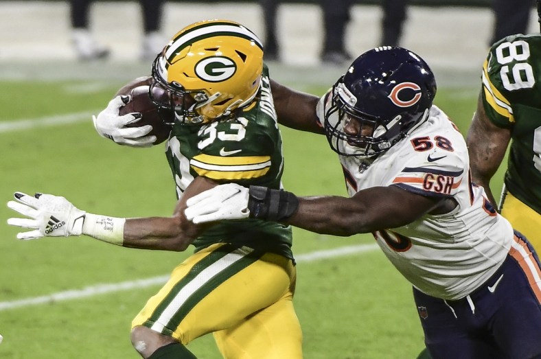 Nov 29, 2020; Green Bay, Wisconsin, USA;  Green Bay Packers running back Aaron Jones (33) tries to break a tackle by Chicago Bears linebacker Roquan Smith (58) in the fourth quarter at Lambeau Field. Mandatory Credit: Benny Sieu-USA TODAY Sports