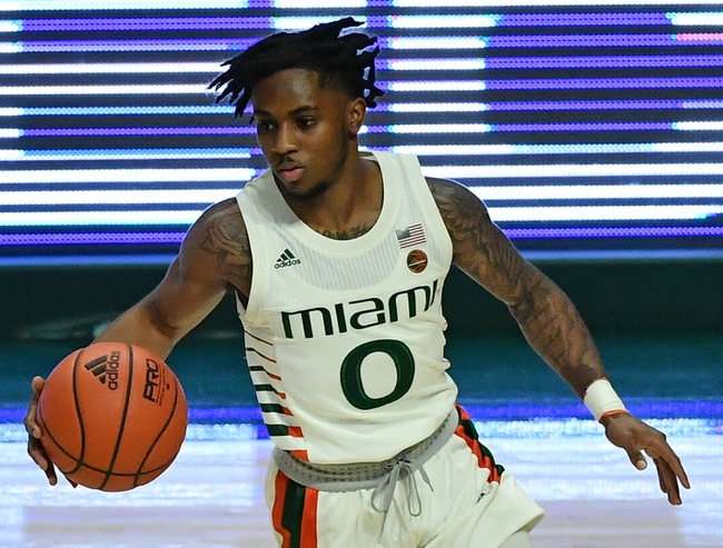 Nov 29, 2020; Coral Gables, Florida, USA; Miami Hurricanes guard Chris Lykes (0) dribbles the ball up the court against the North Florida Ospreys during the first half at Watsco Center. Mandatory Credit: Jasen Vinlove-USA TODAY Sports