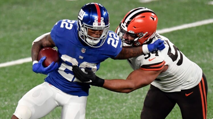 New York Giants running back Wayne Gallman (22) stiff-arms Cleveland Browns defensive end Olivier Vernon (54) in the second half. The Giants lose to the Browns, 20-6, at MetLife Stadium on Sunday, December 20, 2020, in East Rutherford.Nyg Vs Cle