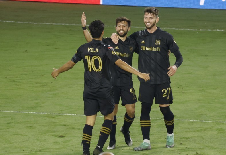 Dec 22, 2020; Orlando, Florida, USA; Los Angeles FC defender Tristan Blackmon (27) and forward Carlos Vela (10) congratulate forward Diego Rossi (9) on a goal against Tigres during the second half of the match at the 2020 SCCL final at Exploria Stadium. Mandatory Credit: Reinhold Matay-USA TODAY Sports