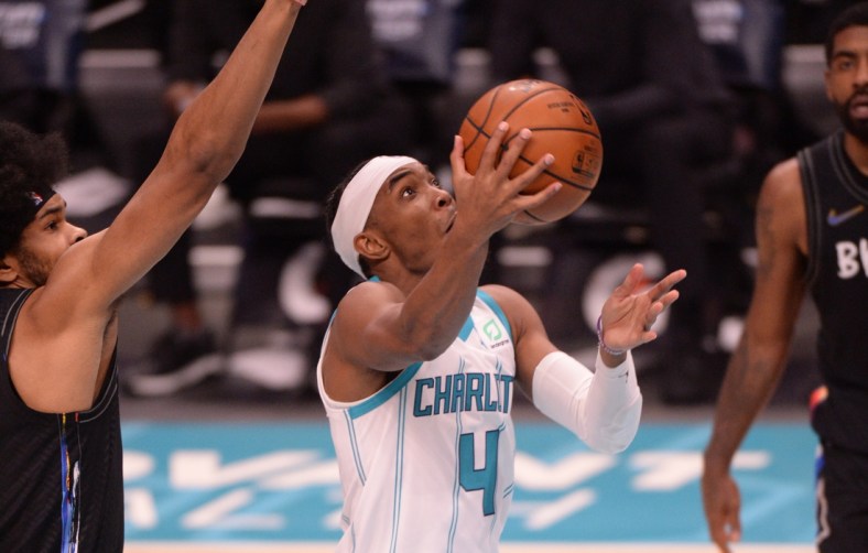 Dec 27, 2020; Charlotte, North Carolina, USA;  Charlotte Hornets guard Devonte' Graham (4) drives in during the second half against the Brooklyn Nets at the Spectrum Center. Hornets won 106-104. Mandatory Credit: Sam Sharpe-USA TODAY Sports
