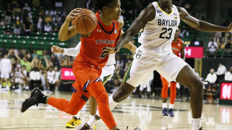 Jan 30, 2021; Waco, Texas, USA; Auburn Tigers guard Sharife Cooper (2) drives past Baylor Bears forward Jonathan Tchamwa Tchatchoua (23) during the second half at Ferrell Center. Mandatory Credit: Raymond Carlin III-USA TODAY Sports