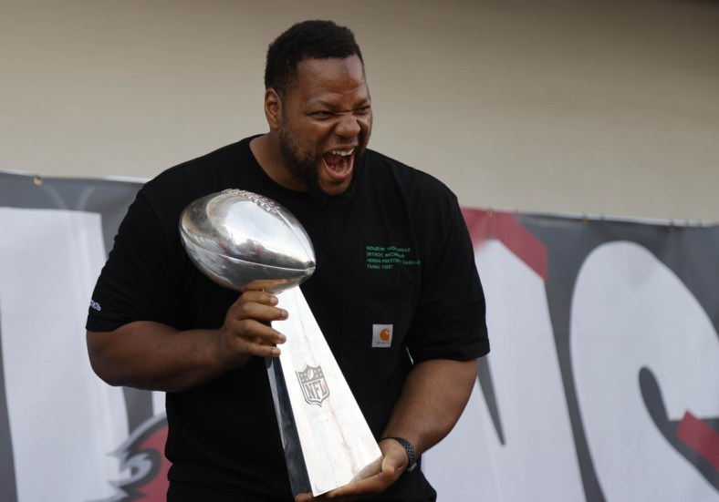 Feb 10, 2021; Tampa Bay, FL, USA;  Tampa Bay Buccaneers defensive end Ndamukong Suh holds the Vince Lombardi Trophy during a boat parade to celebrate victory in Super Bowl LV against the Kansas City Chiefs. Mandatory Credit: Kim Klement-USA TODAY Sports