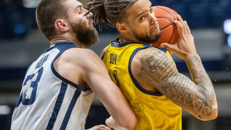 Butler Bulldogs forward Bryce Golden (33) defends Marquette Golden Eagles forward Theo John (4), Wednesday, Feb. 17, 2021, during Marquette at Butler men's basketball from Hinkle Fieldhouse, Indianapolis. Marquette won 73-57.

Butler Takes On Marquette In Men S Hoops