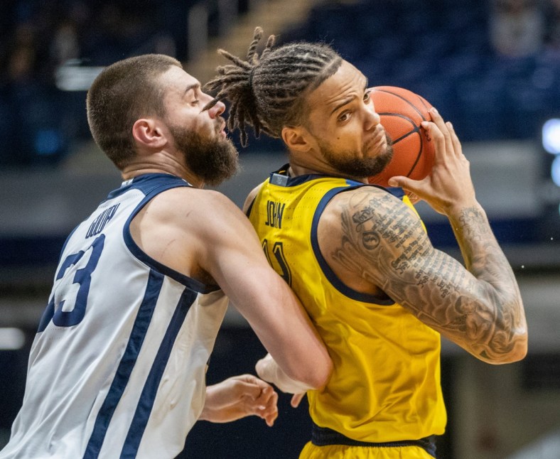 Butler Bulldogs forward Bryce Golden (33) defends Marquette Golden Eagles forward Theo John (4), Wednesday, Feb. 17, 2021, during Marquette at Butler men's basketball from Hinkle Fieldhouse, Indianapolis. Marquette won 73-57.

Butler Takes On Marquette In Men S Hoops