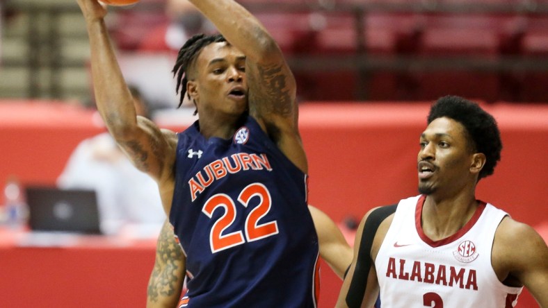 Auburn guard Allen Flanigan (22) works into the lane against Alabama forward Jordan Bruner (2) Tuesday, March 2, 2021, in Coleman Coliseum. [Staff Photo/Gary Cosby Jr.]

Alabama Vs Auburn Sec Basketball