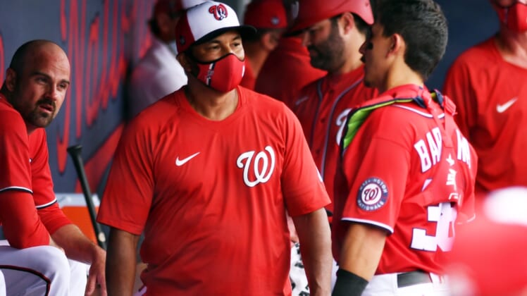 Mar 3, 2021; West Palm Beach, Florida, USA; Washington Nationals manager Dave Martinez (left) talks with catcher Tres Barrera (38) during a spring training game against the Miami Marlins at Ballpark of the Palm Beaches. Mandatory Credit: Jim Rassol-USA TODAY Sports