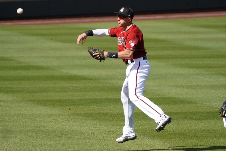 Mar 4, 2021; Salt River Pima-Maricopa, Arizona, USA; Arizona Diamondbacks shortstop Nick Ahmed (13) makes the play for an out against the Los Angeles Angels during a spring training game at Salt River Fields at Talking Stick. Mandatory Credit: Rick Scuteri-USA TODAY Sports