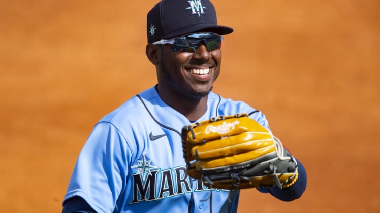 Mar 7, 2021; Tempe, Arizona, USA; Seattle Mariners outfielder Kyle Lewis reacts as he celebrates robbing a home run against the Los Angeles Angels during a Spring Training game at Tempe Diablo Stadium. Mandatory Credit: Mark J. Rebilas-USA TODAY Sports