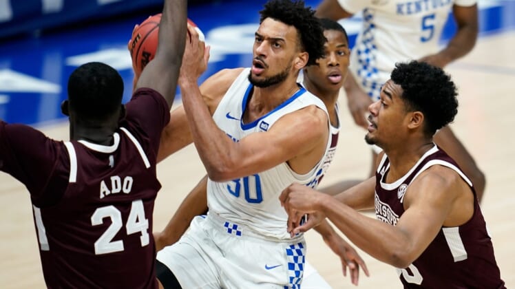 Kentucky forward Olivier Sarr (30) moves to shoot over Mississippi State forward Abdul Ado (24) during the first half of the SEC Men's Basketball Tournament game at Bridgestone Arena in Nashville, Tenn., Thursday, March 11, 2021.Uk Ms Sec 031121 An 009