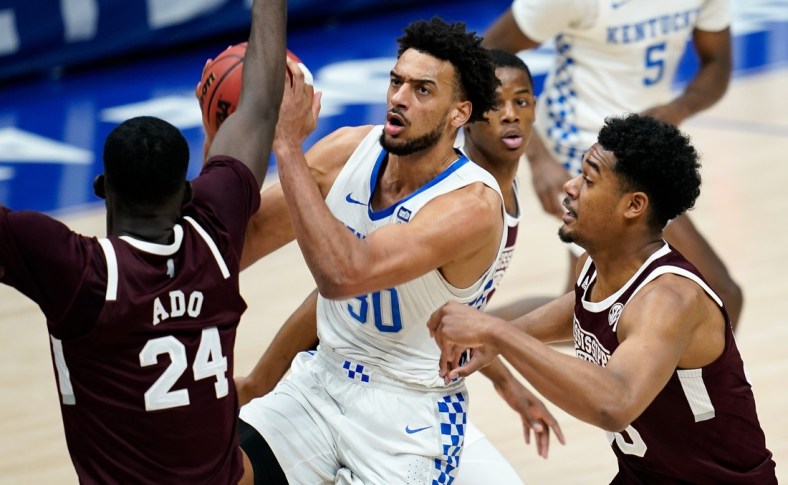 Kentucky forward Olivier Sarr (30) moves to shoot over Mississippi State forward Abdul Ado (24) during the first half of the SEC Men's Basketball Tournament game at Bridgestone Arena in Nashville, Tenn., Thursday, March 11, 2021.

Uk Ms Sec 031121 An 009