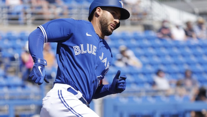 Mar 11, 2021; Dunedin, Florida, USA;  Toronto Blue Jays center fielder George Springer (4) hits a home run during the first inning against the Detroit Tigers during spring training at TD Ballpark. Mandatory Credit: Kim Klement-USA TODAY Sports