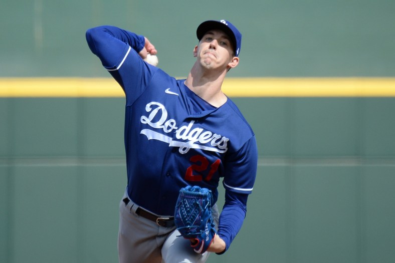 Mar 12, 2021; Goodyear, Arizona, USA; Los Angeles Dodgers starting pitcher Walker Buehler (21) pitches against the Cleveland Indians during the first inning of a spring training game at Goodyear Ballpark. Mandatory Credit: Joe Camporeale-USA TODAY Sports
