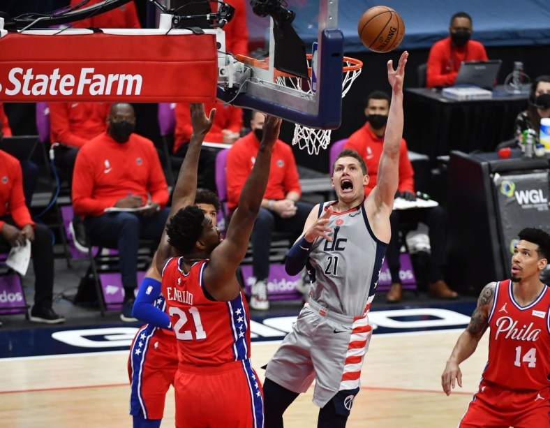 Mar 12, 2021; Washington, District of Columbia, USA; Washington Wizards center Moritz Wagner (21) shoots over Philadelphia 76ers center Joel Embiid (21) during the first quarter at Capital One Arena. Mandatory Credit: Brad Mills-USA TODAY Sports