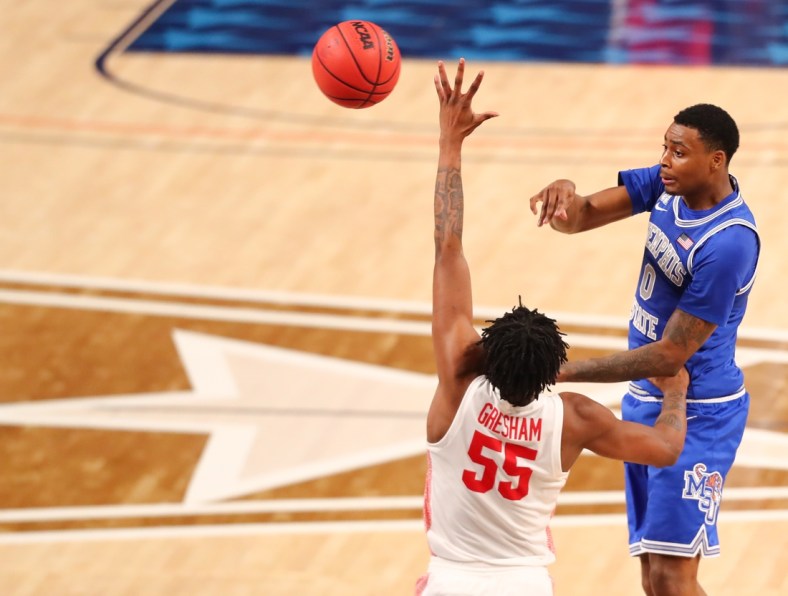 Mar 13, 2021; Fort Worth, TX, USA; Memphis Tigers forward D.J. Jeffries (0) makes a pass against Houston Cougars forward Brison Gresham (55) during the second half at Dickies Arena. Mandatory Credit: Ben Ludeman-USA TODAY Sports