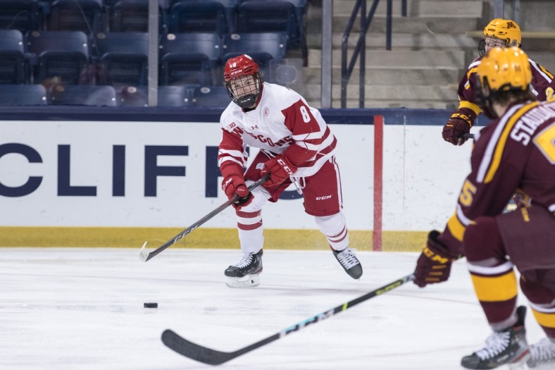 March 16, 2021; South Bend, IN, USA; Wisconsin Badgers forward Cole Caufield (8) advances the puck against the Minnesota Golden Gophers during the Big Ten hockey tournament championship game at Compton Family Ice Arena. Mandatory Credit: John Mersits/South Bend Tribune via USA TODAY NETWORK