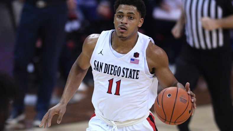 Mar 13, 2021; Las Vegas, Nevada, USA; San Diego State Aztecs forward Matt Mitchell (11) dribbles the ball against the Utah State Aggies during the second half at the Thomas & Mack Center. Mandatory Credit: Orlando Ramirez-USA TODAY Sports