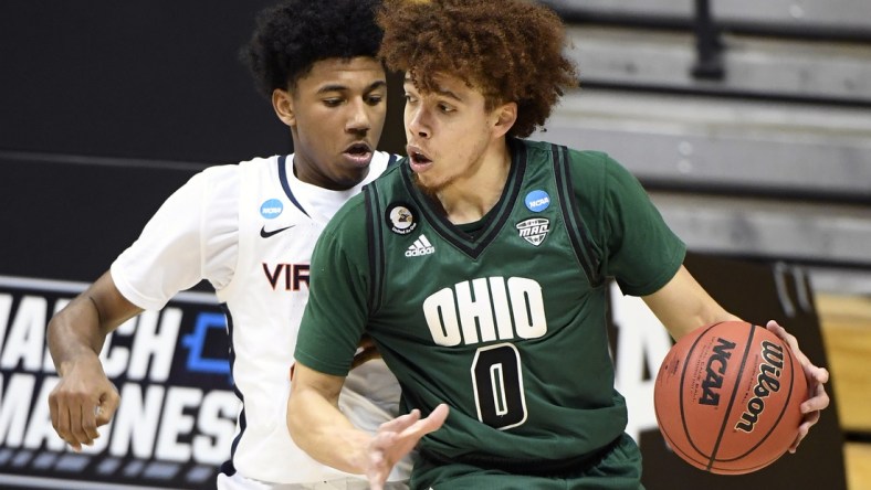 Ohio Bobcats guard Jason Preston (0) looks for a shot guarded by Virginia Cavaliers guard Reece Beekman (2)  during the first round of the 2021 NCAA Tournament on Saturday, March 20, 2021, at Simon Skjodt Assembly Hall in Bloomington, Ind. Mandatory Credit: Rich Janzaruk/IndyStar via USA TODAY Sports