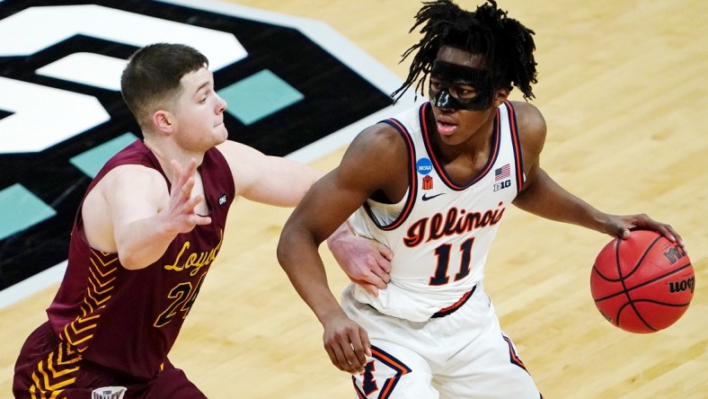 Mar 21, 2021; Indianapolis, Indiana, USA; Illinois Fighting Illini guard Ayo Dosunmu (11) dribbles while defended by Loyola Ramblers guard Tate Hall (24) during the second half in the second round of the 2021 NCAA Tournament at Bankers Life Fieldhouse. Mandatory Credit: Kirby Lee-USA TODAY Sports