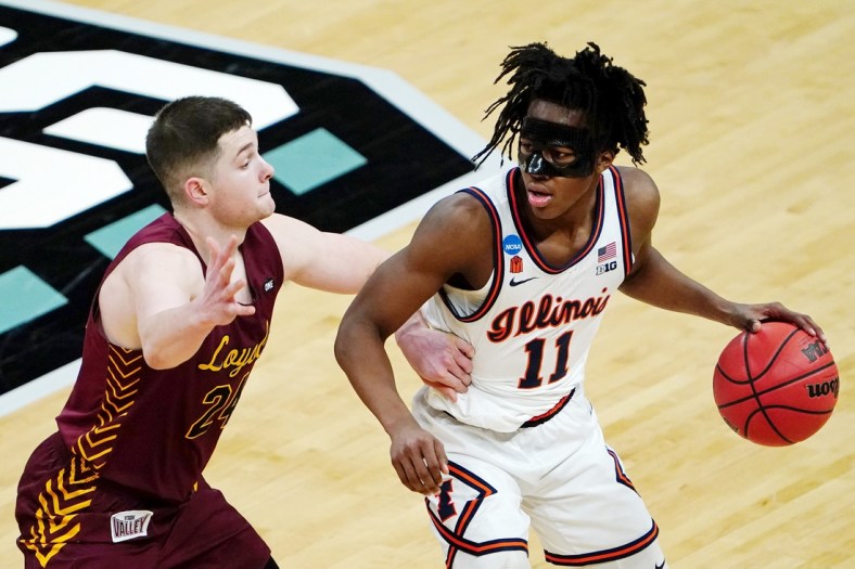 Mar 21, 2021; Indianapolis, Indiana, USA; Illinois Fighting Illini guard Ayo Dosunmu (11) dribbles while defended by Loyola Ramblers guard Tate Hall (24) during the second half in the second round of the 2021 NCAA Tournament at Bankers Life Fieldhouse. Mandatory Credit: Kirby Lee-USA TODAY Sports