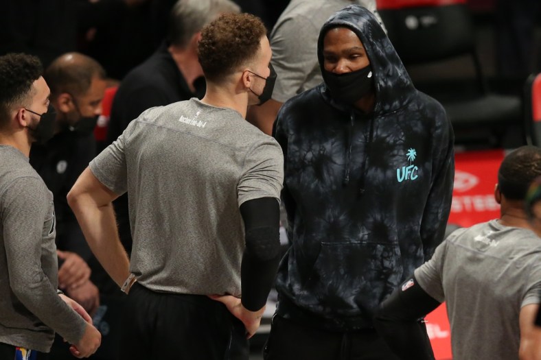 Mar 21, 2021; Brooklyn, New York, USA; Brooklyn Nets power forward Kevin Durant (7) talks to power forward Blake Griffin (2) during the fourth quarter against the Washington Wizards at Barclays Center. Mandatory Credit: Brad Penner-USA TODAY Sports