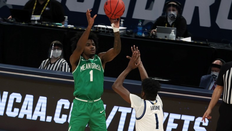 Mar 21, 2021; Indianapolis, Indiana, USA; North Texas Mean Green guard Mardrez McBride (1) shoots against Villanova Wildcats guard Bryan Antoine (1) in the second half in the second round of the 2021 NCAA Tournament at Bankers Life Fieldhouse. Mandatory Credit: Trevor Ruszkowski-USA TODAY Sports