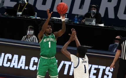 Mar 21, 2021; Indianapolis, Indiana, USA; North Texas Mean Green guard Mardrez McBride (1) shoots against Villanova Wildcats guard Bryan Antoine (1) in the second half in the second round of the 2021 NCAA Tournament at Bankers Life Fieldhouse. Mandatory Credit: Trevor Ruszkowski-USA TODAY Sports