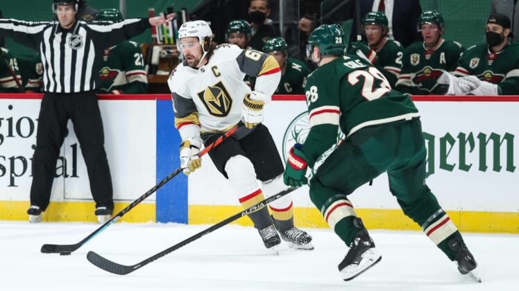 Mar 10, 2021; Saint Paul, Minnesota, USA; Vegas Golden Knights right wing Mark Stone (61) skates with the puck while Minnesota Wild defenseman Ian Cole (28) defends in the first period at Xcel Energy Center. Mandatory Credit: David Berding-USA TODAY Sports