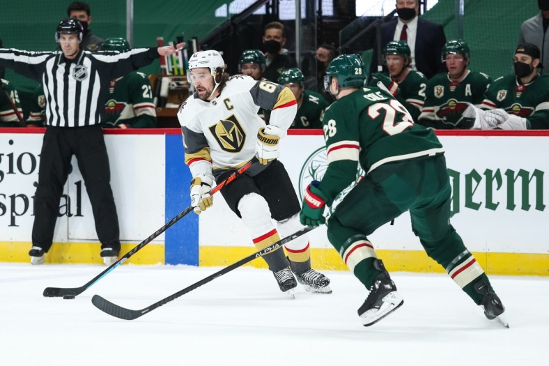 Mar 10, 2021; Saint Paul, Minnesota, USA; Vegas Golden Knights right wing Mark Stone (61) skates with the puck while Minnesota Wild defenseman Ian Cole (28) defends in the first period at Xcel Energy Center. Mandatory Credit: David Berding-USA TODAY Sports