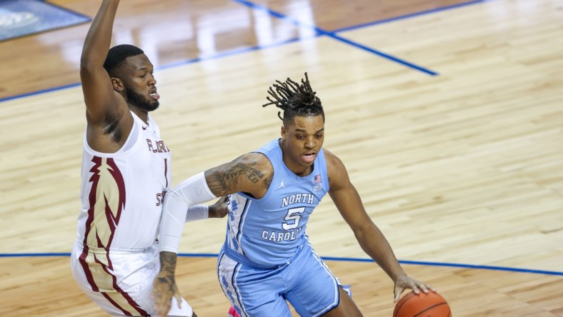 Mar 12, 2021; Greensboro, North Carolina, USA; North Carolina Tar Heels forward Armando Bacot (5) drives to the basket against Florida State Seminoles forward RaiQuan Gray (1) in the first half in the 2021 ACC tournament semifinal game at Greensboro Coliseum. The Florida State Seminoles won 69-66. Mandatory Credit: Nell Redmond-USA TODAY Sports