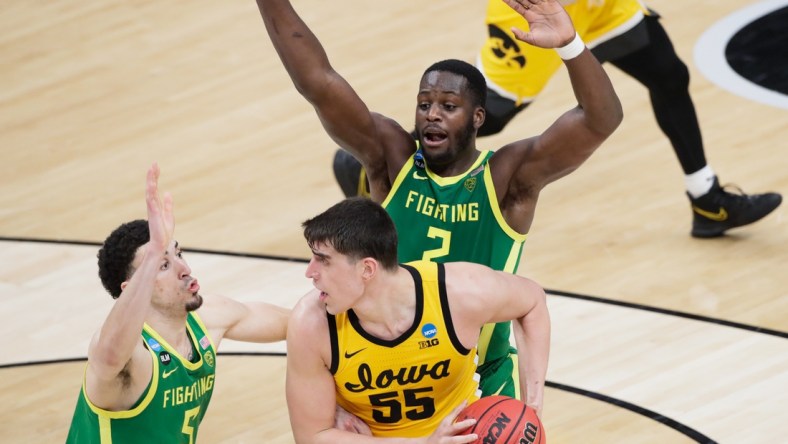 Iowa Hawkeyes center Luka Garza (55) attempts to evade Oregon Ducks guard Chris Duarte (5) and forward Eugene Omoruyi (2) during the second round of the 2021 NCAA Tournament on Monday, March 22, 2021, at Bankers Life Fieldhouse in Indianapolis, Ind. Mandatory Credit: Barbara Perenic/IndyStar via USA TODAY Sports