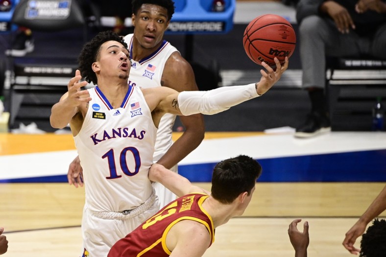 Mar 22, 2021; Indianapolis, Indiana, USA; Kansas Jayhawks forward Jalen Wilson (10) grabs onto the loose ball during the first half in the second round of the 2021 NCAA Tournament against the Southern California Trojans at Hinkle Fieldhouse. Mandatory Credit: Marc Lebryk-USA TODAY Sports