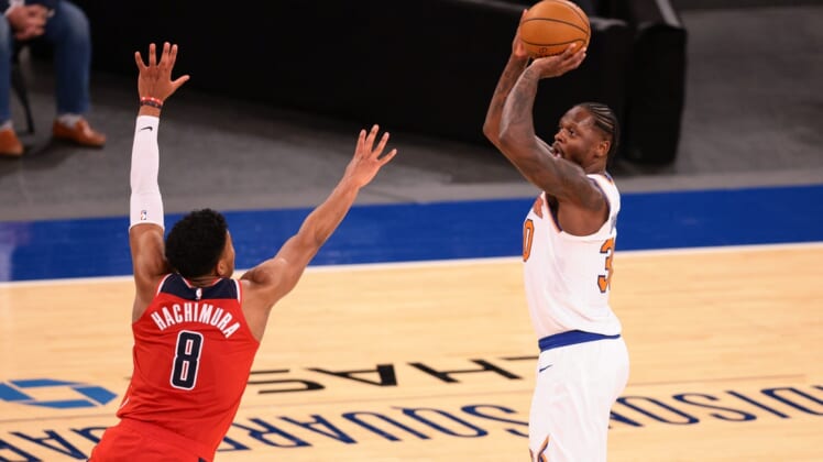 Mar 23, 2021; New York, New York, USA; New York Knicks forward Julius Randle (30) shoots the ball over Washington Wizards forward Rui Hachimura (8) during the second half at Madison Square Garden. Mandatory Credit: Vincent Carchietta-USA TODAY Sports