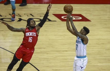 Mar 24, 2021; Houston, Texas, USA; Charlotte Hornets guard Malik Monk (1) shoots the ball as Houston Rockets guard Ben McLemore (16) defends during the second quarter at Toyota Center. Mandatory Credit: Troy Taormina-USA TODAY Sports