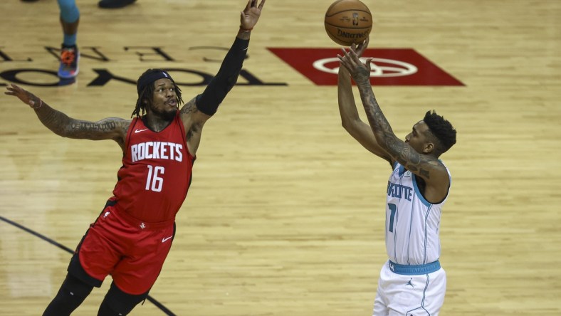 Mar 24, 2021; Houston, Texas, USA; Charlotte Hornets guard Malik Monk (1) shoots the ball as Houston Rockets guard Ben McLemore (16) defends during the second quarter at Toyota Center. Mandatory Credit: Troy Taormina-USA TODAY Sports