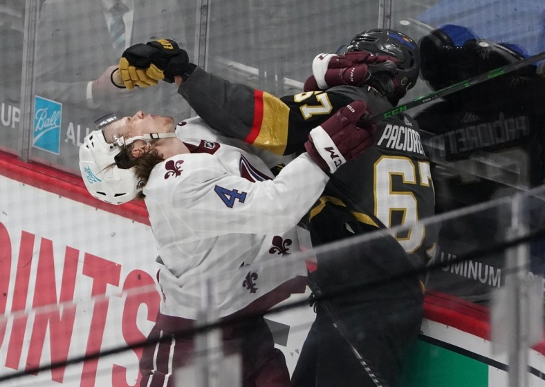 Mar 25, 2021; Denver, Colorado, USA; Colorado Avalanche defenseman Bowen Byram (4) and Vegas Golden Knights left wing Max Pacioretty (67) fight in the first period at Ball Arena. Mandatory Credit: Ron Chenoy-USA TODAY Sports