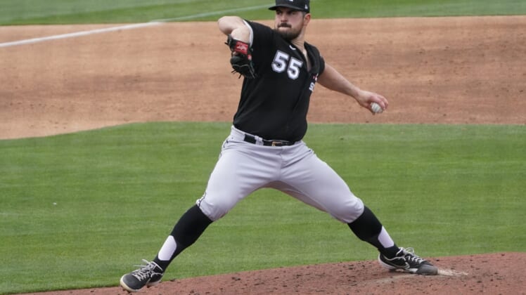 Mar 26, 2021; Phoenix, Arizona, USA; Chicago White Sox starting pitcher Carlos Rodon (55) throws against the Milwaukee Brewers during a spring training game at American Family Fields of Phoenix. Mandatory Credit: Rick Scuteri-USA TODAY Sports