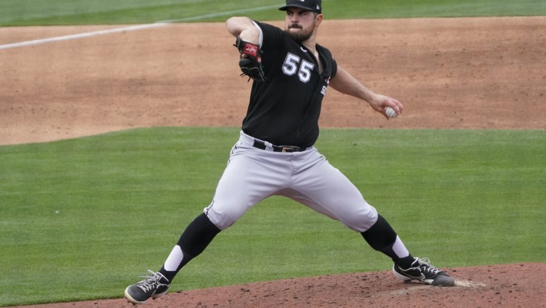 Mar 26, 2021; Phoenix, Arizona, USA; Chicago White Sox starting pitcher Carlos Rodon (55) throws against the Milwaukee Brewers during a spring training game at American Family Fields of Phoenix. Mandatory Credit: Rick Scuteri-USA TODAY Sports