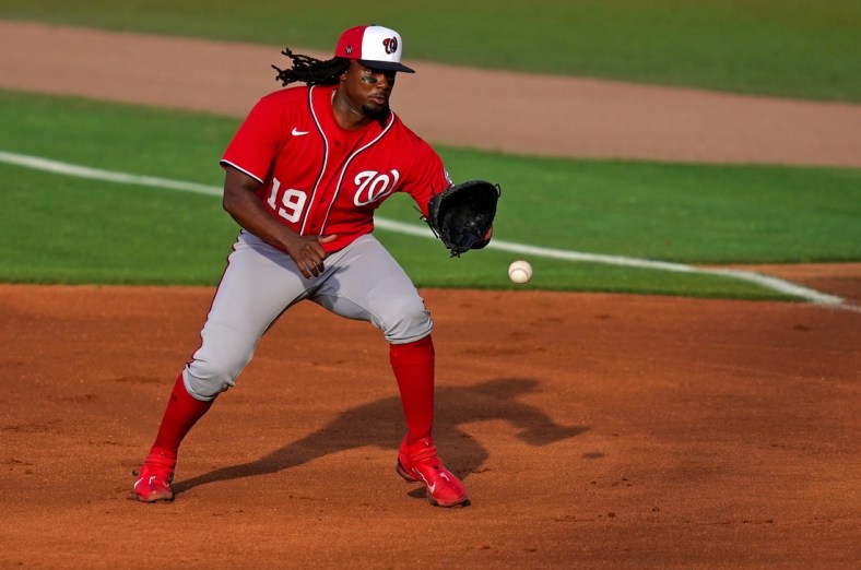 Mar 26, 2021; Port St. Lucie, Florida, USA; Washington Nationals first baseman Josh Bell (19) fields the ground ball before putting out New York Mets center fielder Brandon Nimmo (9, not pictured) in the 1st inning of the spring training game at Clover Park. Mandatory Credit: Jasen Vinlove-USA TODAY Sports