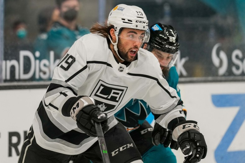 Mar 24, 2021; San Jose, California, USA;  Los Angeles Kings right wing Alex Iafallo (19) chases after the puck during the first period against the San Jose Sharks at SAP Center at San Jose. Mandatory Credit: Stan Szeto-USA TODAY Sports